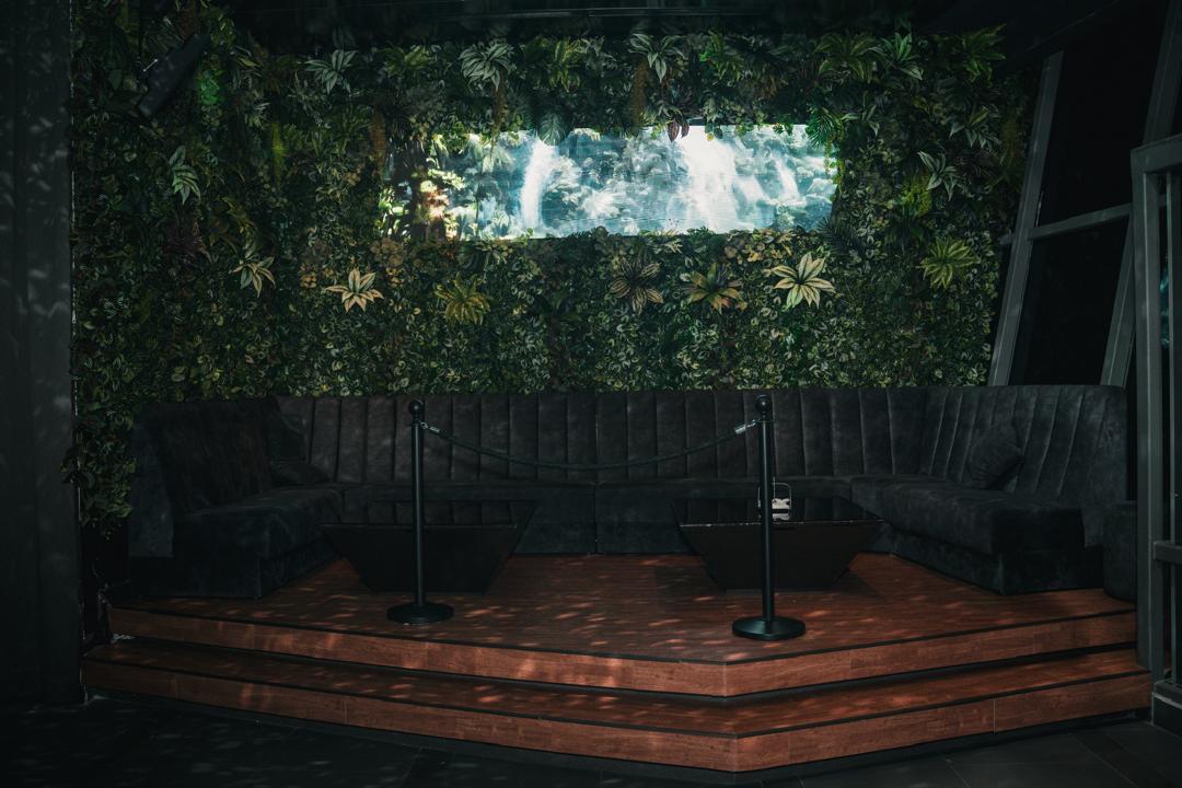 Biophilic booth with digital waterfall